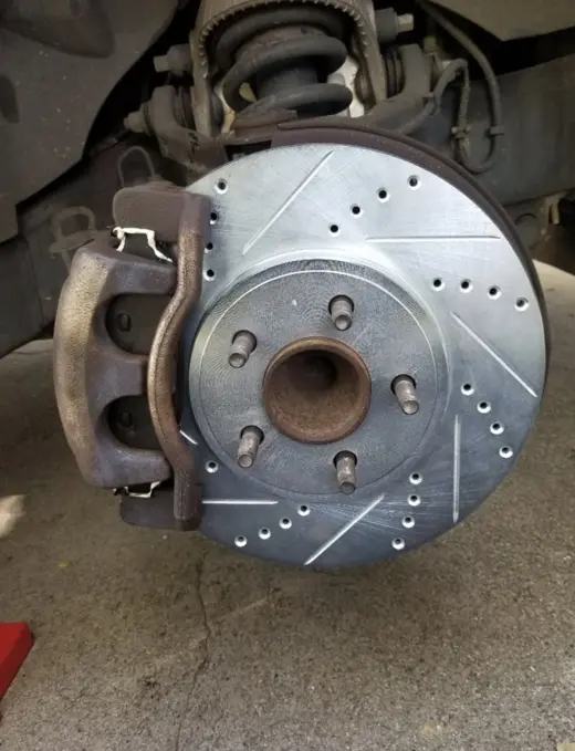 New drilled and slotted rotor on, caliper going back on